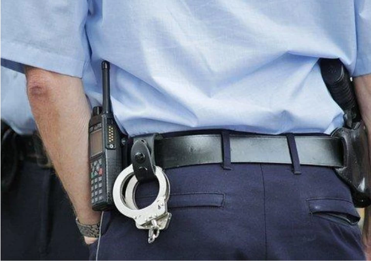 Security guard’s waist with radio and handcuffs