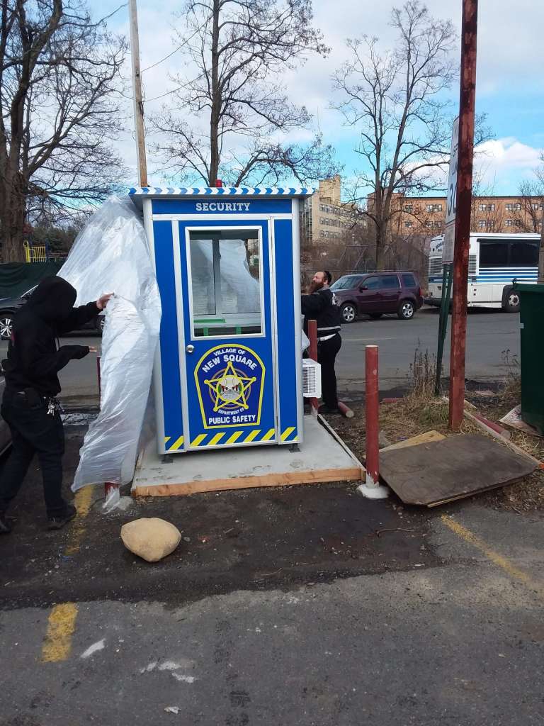 4×4 Security Guard Booth in NewSquare, NY with Custom Graphics, Sliding Windows, Swing Door, and Outside Spotlights