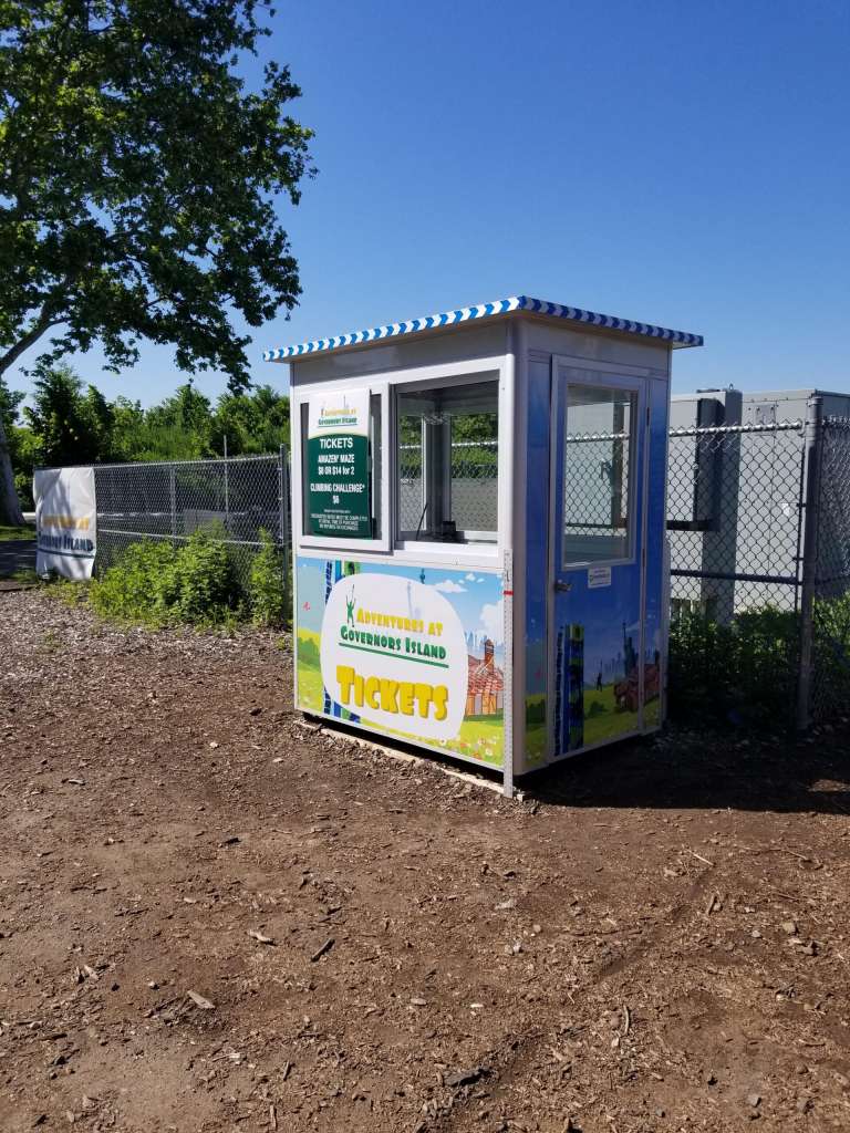 4×6 Ticket Booth in Governor’s Island, NY on Festival Grounds with Perimeter Security Fencing, Swing Door, and Sliding Windows